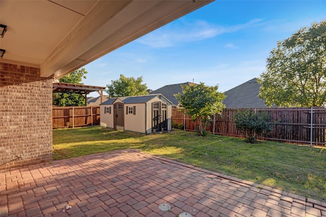 view of patio featuring an outbuilding, a shed, and a fenced backyard