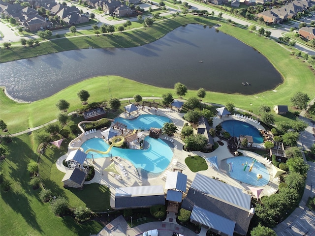 drone / aerial view featuring a water view and a residential view