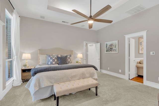 bedroom featuring light colored carpet, baseboards, and visible vents