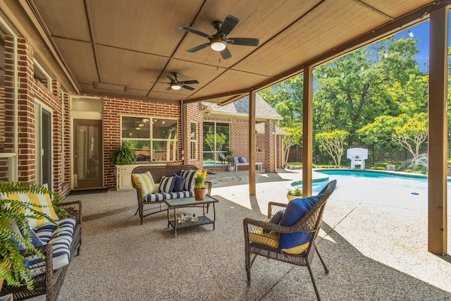 view of patio featuring outdoor lounge area, a ceiling fan, a fenced in pool, and a fenced backyard