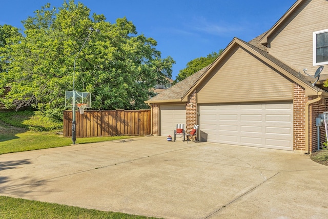 exterior space featuring driveway and fence