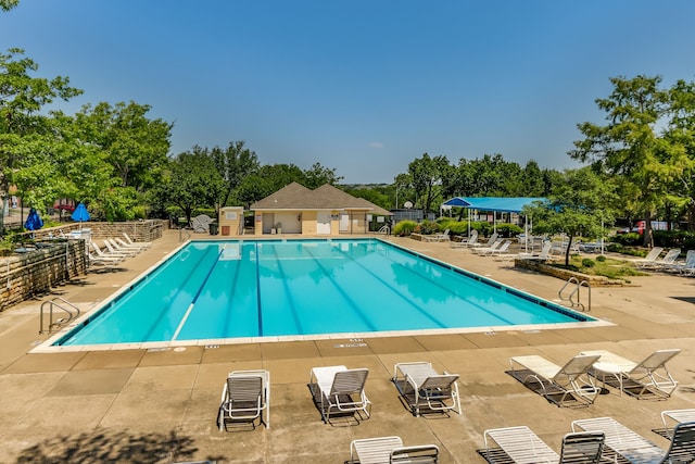 pool with fence and a patio area