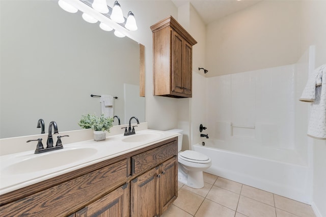 bathroom with double vanity, tile patterned flooring, toilet, and a sink