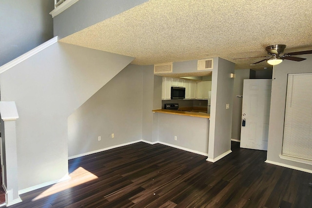 unfurnished living room featuring baseboards, a ceiling fan, dark wood-style floors, and visible vents