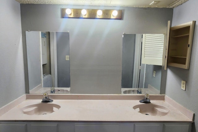 bathroom featuring a sink and double vanity