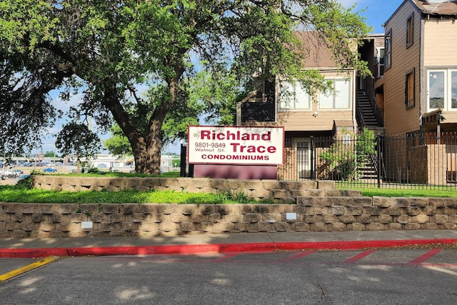 community sign featuring fence