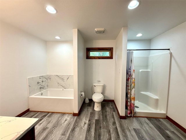 111 County Road 2156, Quitman, TX 75783 - bathroom with a bath, toilet, wood finished floors, and baseboards