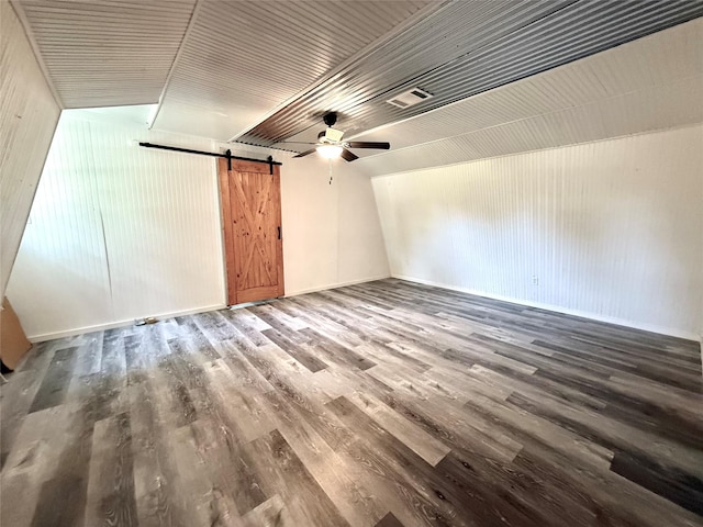 111 County Road 2156, Quitman, TX 75783 - additional living space featuring baseboards, wood finished floors, ceiling fan, and a barn door