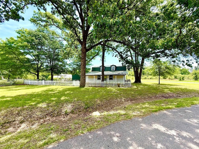 111 County Road 2156, Quitman, TX 75783 - view of front of home with a front lawn, a porch, and a fenced front yard
