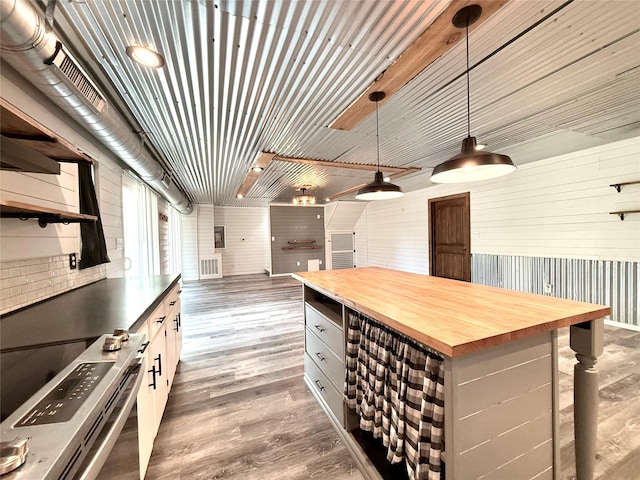 111 County Road 2156, Quitman, TX 75783 - kitchen with visible vents, wood finished floors, pendant lighting, butcher block counters, and electric stove