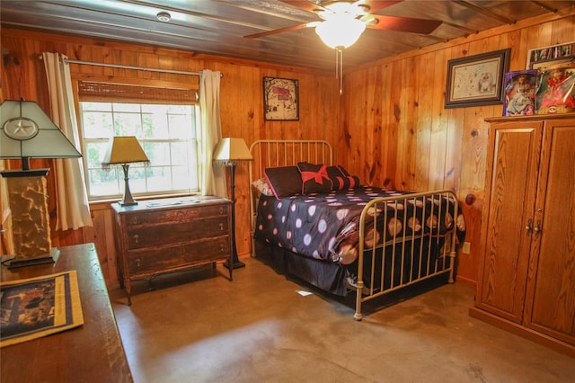 14615 County Road 2337, Tyler, TX 75707 - bedroom featuring wooden walls and finished concrete flooring