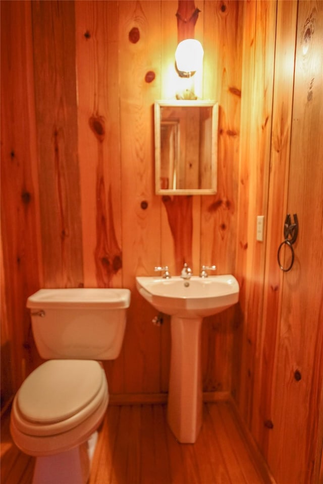 14615 County Road 2337, Tyler, TX 75707 - bathroom with wood walls, baseboards, wood finished floors, and toilet