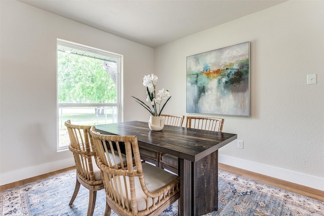 dining room featuring wood finished floors and baseboards