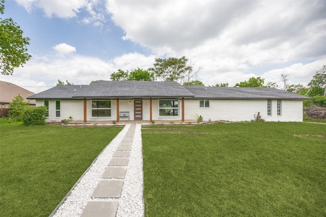 single story home with a front lawn and brick siding