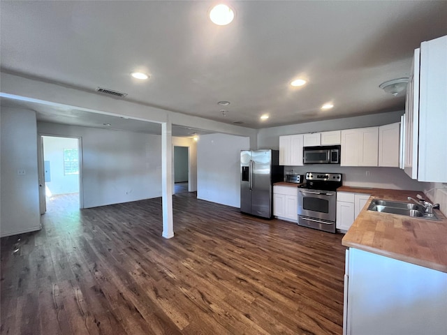 715 Elm St, Mckinney, TX 75069 - kitchen with stainless steel appliances, a sink, open floor plan, dark wood-style flooring, and recessed lighting