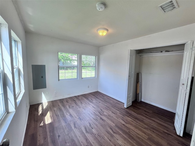 715 Elm St, Mckinney, TX 75069 - unfurnished bedroom featuring electric panel, dark wood finished floors, baseboards, and a closet