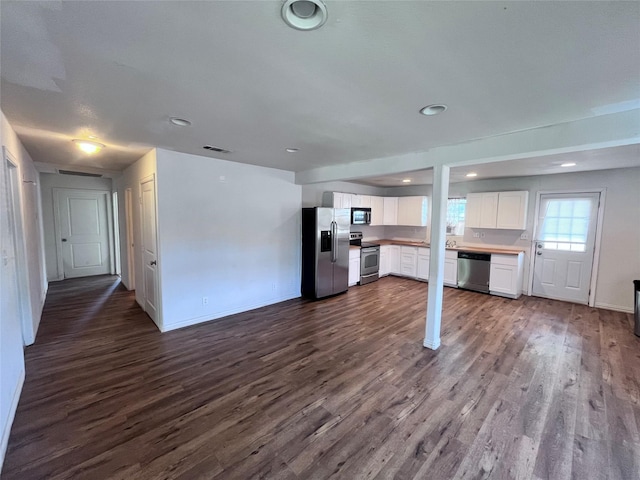 715 Elm St, Mckinney, TX 75069 - kitchen featuring stainless steel appliances, white cabinets, dark wood-style floors, recessed lighting, and baseboards