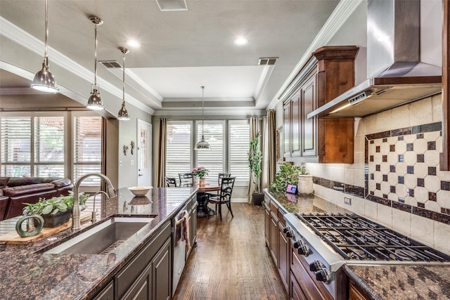 kitchen featuring wall chimney exhaust hood, stainless steel appliances, a sink, dark wood finished floors, and visible vents