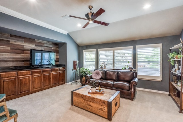 living area with lofted ceiling, light carpet, a ceiling fan, and baseboards