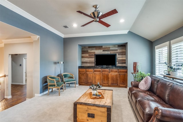 living area featuring light colored carpet, ceiling fan, crown molding, and visible vents