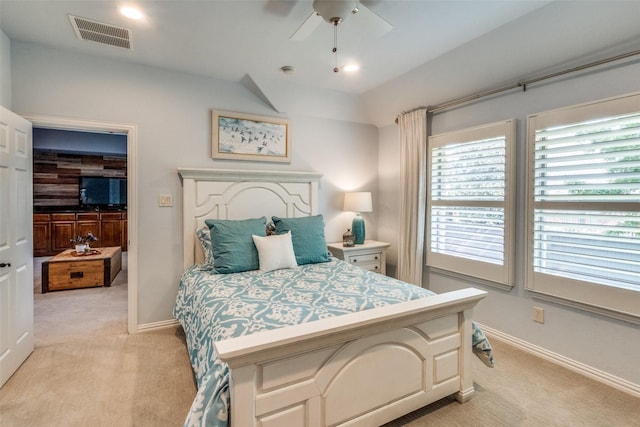 bedroom with light carpet, baseboards, visible vents, and ceiling fan
