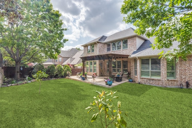 rear view of house featuring a fenced backyard, brick siding, a yard, and a patio