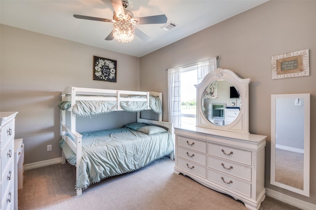 bedroom featuring baseboards, a ceiling fan, visible vents, and light colored carpet
