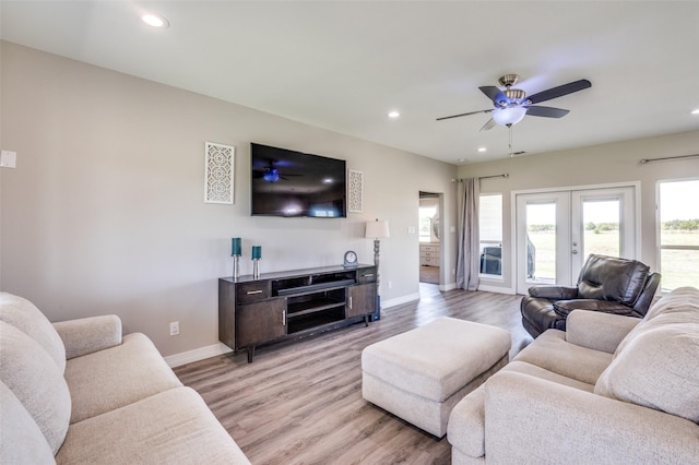 living room with recessed lighting, light wood-style flooring, and baseboards