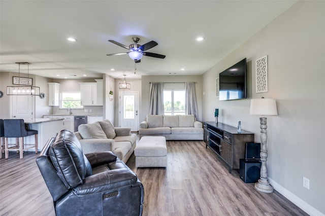 living room with light wood-style flooring, baseboards, recessed lighting, and ceiling fan