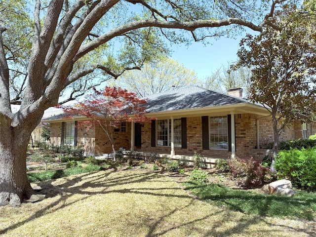 11147 Carissa Dr, Dallas, TX 75218 - single story home with covered porch, a chimney, brick siding, and roof with shingles