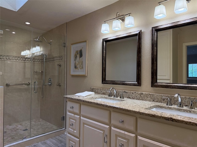 11147 Carissa Dr, Dallas, TX 75218 - full bathroom with a textured wall, a sink, double vanity, and a stall shower