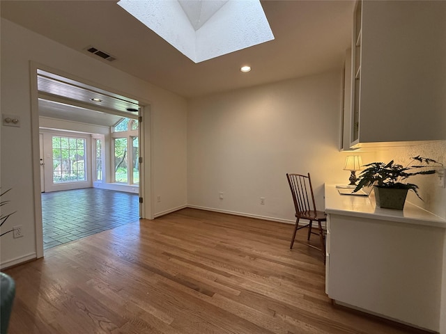 11147 Carissa Dr, Dallas, TX 75218 - unfurnished living room featuring baseboards, visible vents, recessed lighting, a skylight, and wood finished floors
