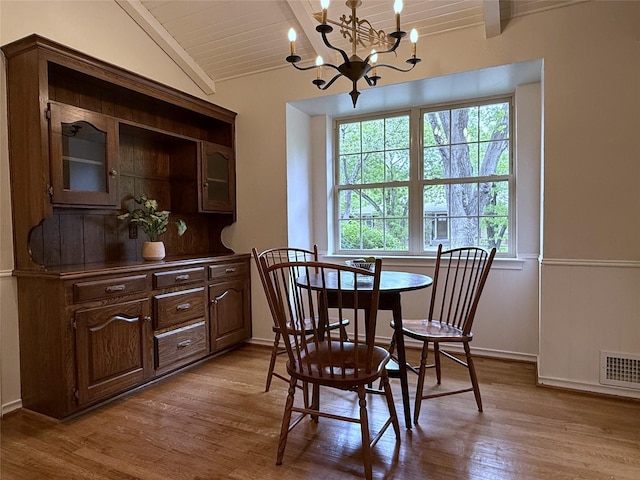 11147 Carissa Dr, Dallas, TX 75218 - dining area with lofted ceiling with beams, light wood-type flooring, wood ceiling, an inviting chandelier, and visible vents