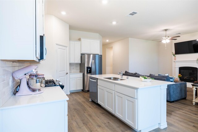 2712 Cain Dr, Anna, TX 75409 - kitchen with light wood-type flooring, appliances with stainless steel finishes, open floor plan, and a sink