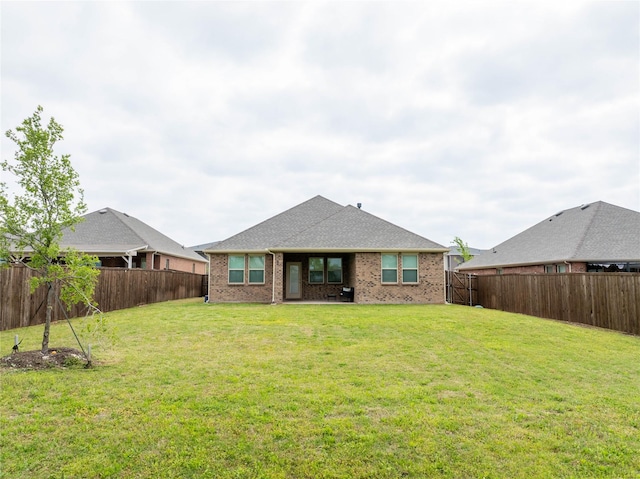 2712 Cain Dr, Anna, TX 75409 - back of house with a fenced backyard, brick siding, and a yard