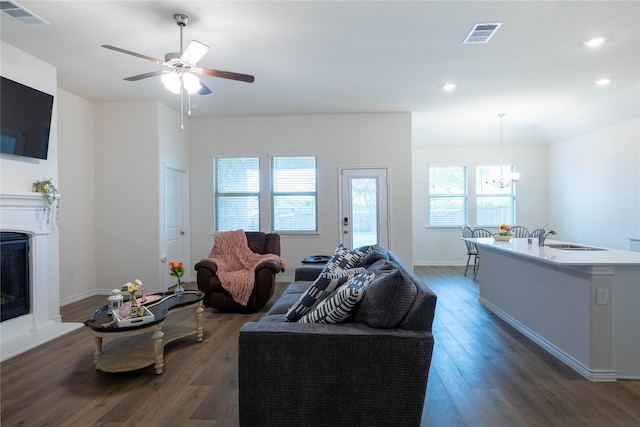 2712 Cain Dr, Anna, TX 75409 - living room featuring wood finished floors, plenty of natural light, a glass covered fireplace, visible vents, and recessed lighting