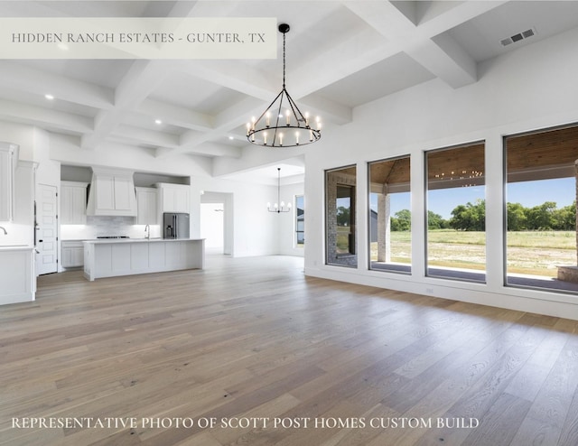 TBDLOT2 Jolene Ct, Van Alstyne, TX 75495 - unfurnished living room with coffered ceiling, a chandelier, beamed ceiling, and light wood-type flooring