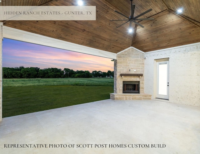 TBDLOT2 Jolene Ct, Van Alstyne, TX 75495 - patio terrace at dusk with a lawn, an outdoor stone fireplace, and a ceiling fan