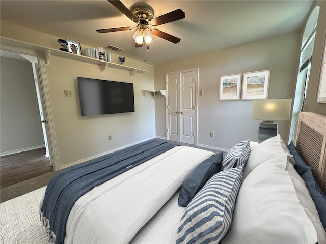 carpeted bedroom featuring baseboards, visible vents, and ceiling fan
