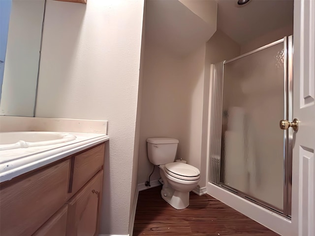 full bathroom with wood finished floors, vanity, toilet, and a stall shower