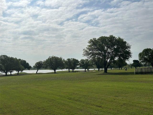 surrounding community with a yard and a water view