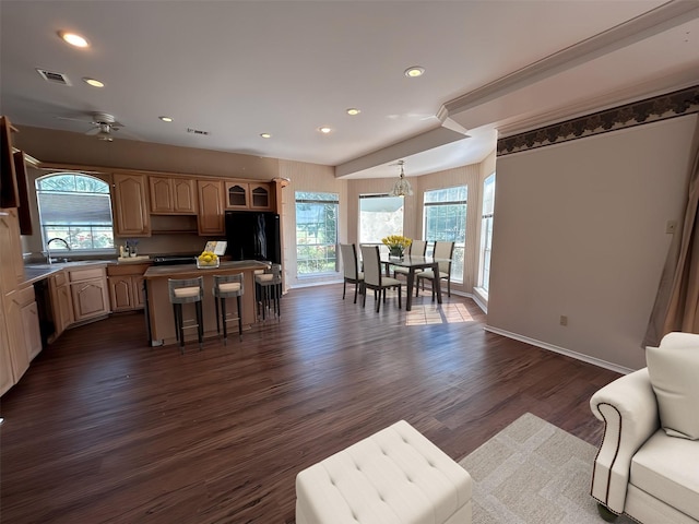 living room with dark wood-type flooring, visible vents, and recessed lighting