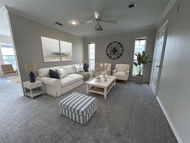 carpeted living area with a ceiling fan, baseboards, ornamental molding, and visible vents