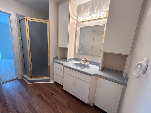 full bath featuring wood finished floors, vanity, and a stall shower