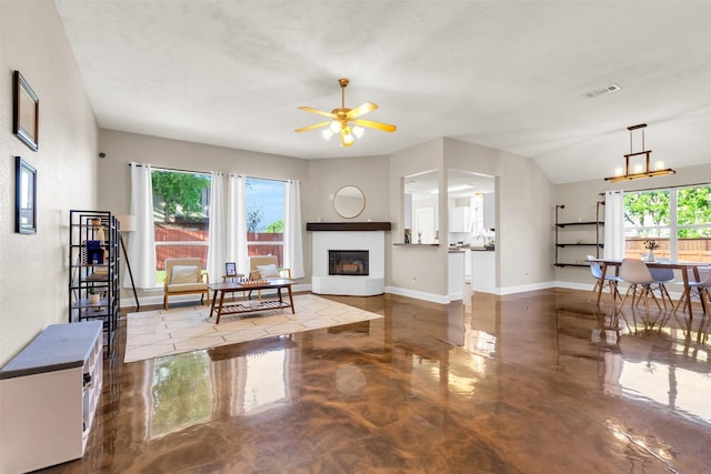 500 Nathan St, Saginaw, TX 76179 - living room with healthy amount of natural light, finished concrete floors, a ceiling fan, and a glass covered fireplace