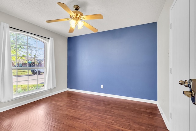 500 Nathan St, Saginaw, TX 76179 - empty room with wood finished floors, baseboards, a ceiling fan, and a textured ceiling