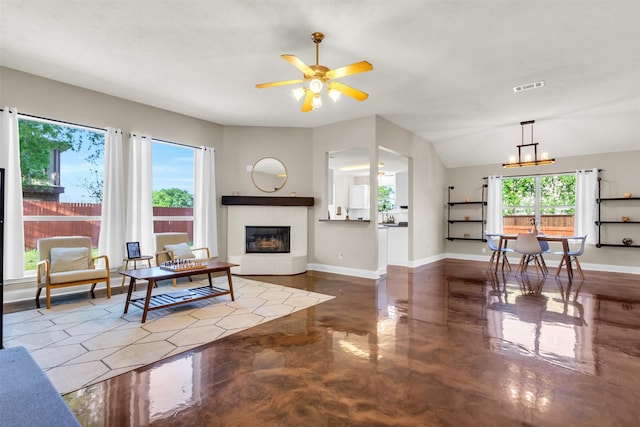 500 Nathan St, Saginaw, TX 76179 - living area with a glass covered fireplace, ceiling fan, baseboards, and concrete floors