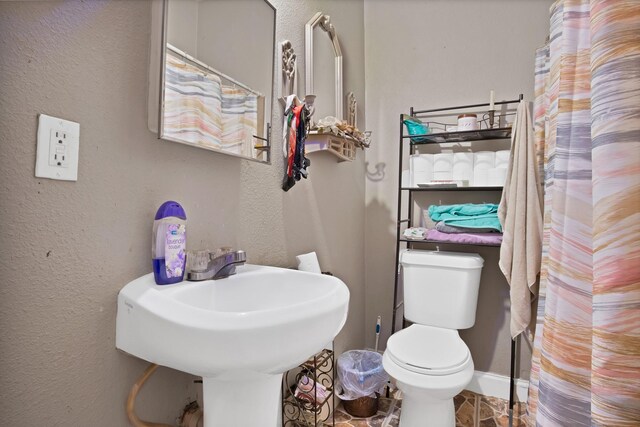 3431 Ada Ave, Fort Worth, TX 76105 - bathroom with a textured wall, a sink, and toilet