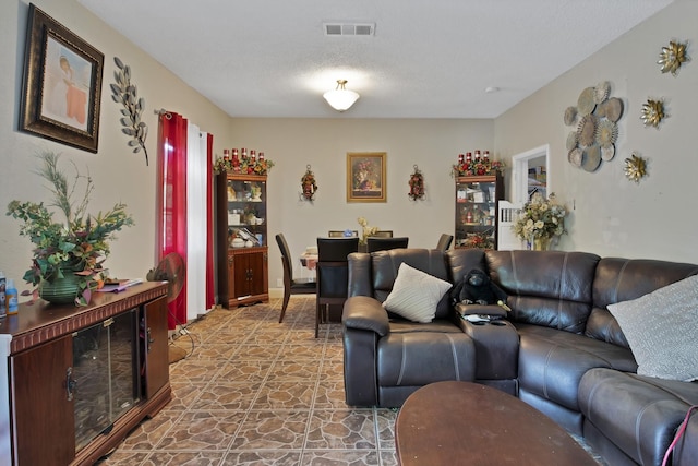 3431 Ada Ave, Fort Worth, TX 76105 - living room featuring visible vents, stone finish flooring, and a textured ceiling