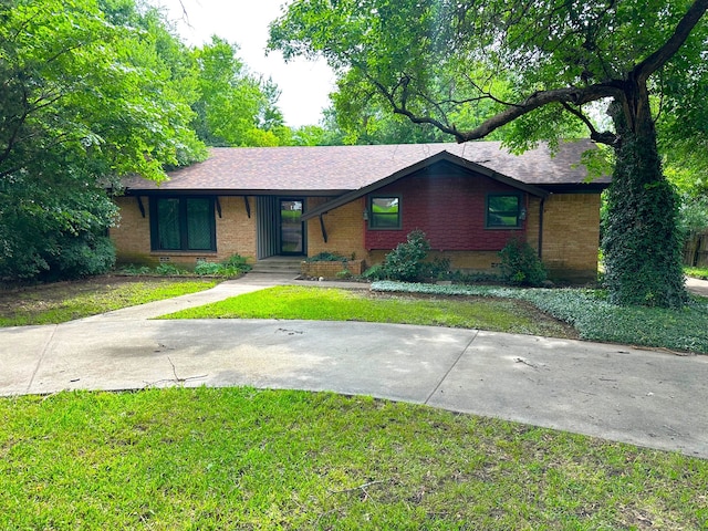 2713 Yorkshire Dr, Sherman, TX 75092 - view of front of house featuring brick siding, a front lawn, and a shingled roof